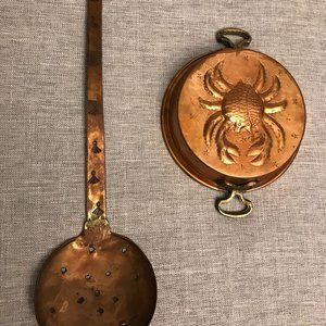 Vintage copper mold featuring embossed crab and vintage copper spoon.